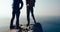 Women hikers looking at the view on seaside mountain top rock edge