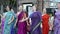 Women in Hindu traditional costumes, dancing and singing Hare Krishna mantra