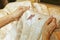 Women hold bed sheet with period blood spot stains on blur background. Need to be cleaning.