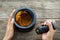 The Women hold pestle with mortar and spice paste of thai popular food red curry on rustic wooden background.