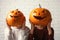 Women holding Halloween pumpkin head jack lanterns