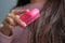 women holding messy hair in hands, Combing with brush and pulls long hair, Long disheveled hair