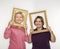 Women holding picture frames.