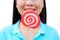 Women holding round swirl lollipop colorful