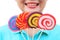 Women holding round swirl lollipop colorful