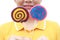 Women holding round swirl lollipop colorful