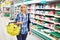 Women housewife with yellow basket shopping in dairy department