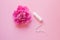 Women intimate hygiene product, tampon and beautiful fresh peony flower on pink background, flat layout