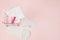 Women intimate hygiene products - sanitary pads and tampons on pink background, copy space. Menstrual period concept. Top view,