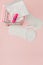 Women intimate hygiene products - sanitary pads and tampons on pink background, copy space. Menstrual period concept. Top view,