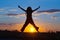 women joyfully jumping at sunset