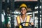 Women labor worker at forklift driver position with safety suit and helmet happy smile enjoy working in industry factory logistic