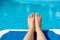 women legs pedicure nails splashing in tropical swimming summer pool