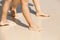 Women legs walk on a wet sandy beach