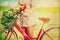 Women lifestyle in spring with colorful flowers in basket of red bicycle