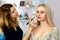 Women make up artist with her blonde model