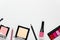 Women makeup cosmetics elegant background with place for text. Facial powder, eyeliner pencil, blusher border on light grey