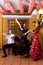 Women and man in traditional flamenco dresses dance during the Feria de Abril on April Spain