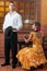 Women and man in traditional flamenco dresses dance during the Feria de Abril on April Spain