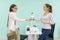 Women manicurist and client shake hands in the salon for the care of hands and nails