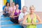 Women meditating with hands joined during fitness class