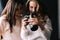 Women model and female photographer watching photos in studio.