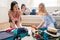 Women packing suitcases for vacation together at home, getting ready to travel concept