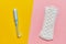 Women pad with a tampon on a yellow and pink background