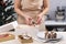Women pastry chef makes Gingerbread house. Baking Christmas sweets