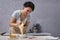 Women pastry chef prepares cake from shortcakes and cream. Process of making cake