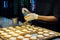 Women pastry chef are taking a pastry brush and brushing egg wash on top of cheese tart in the kitchen at the bakery shop. vintage