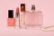 Women perfumes and cosmetics on a pink background