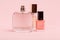 Women perfumes and cosmetics on a pink background