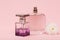 Women perfumes with flower on a pink background