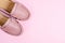 Women pink fashion shoes on pink background.