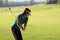 Women player golf swing shot on course