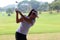 Women player golf swing shot on course