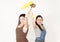 Women posing with a paint roller and mallet