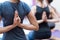 Women practicing yoga: reverse prayer pose