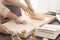 Women preparing a dough on pastry board