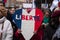 Women protesting with a tricolor heart in french : liberte, traduction in english :