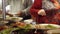 Women putting food in plates standing at buffet in modern restaurant.