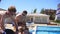 Women receiving massage from their boyfriends at a beautiful villa by the pool. Slowmotion shot