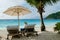women relaxing in a Beach chairs at a tropical beach sunbed chair and umbrella in Mahe Seychelles