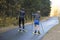 Women ride roller skis in the autumn Park