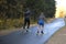 Women ride roller skis in the autumn Park