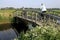 Women riding bike in polder landscape