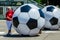 Women rolling giant soccer balls