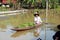 Women rowing with lots of raw bananas.