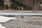 Women with rucksack and boy walking on dry bottom of KlÃ¶ntalersee lake